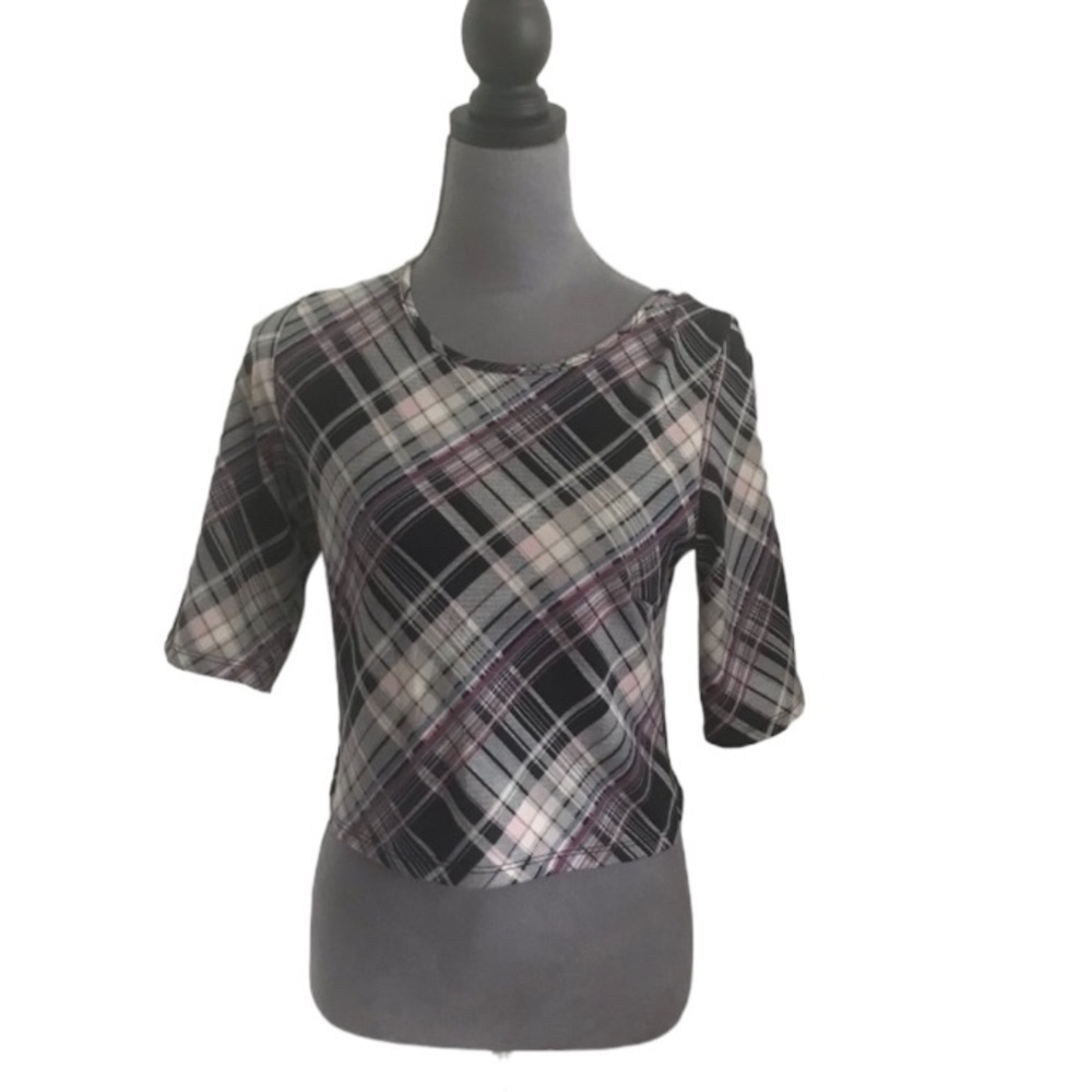 Spread by A purple and black plaid crop top.